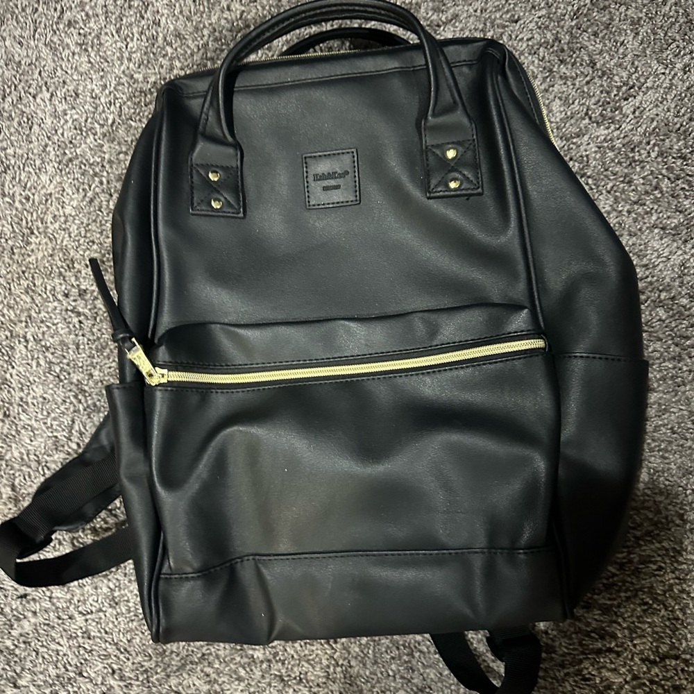 Elegant Black and Gold Backpack with Structured Design